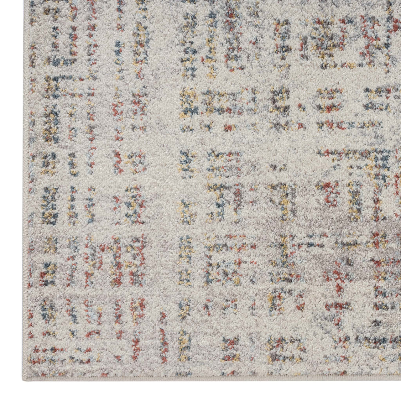 Beige runner rug with multi-colored abstract pattern and textured weave.