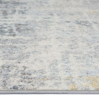 Grey multi-colored abstract patterned runner rug with subtle blue and yellow accents.