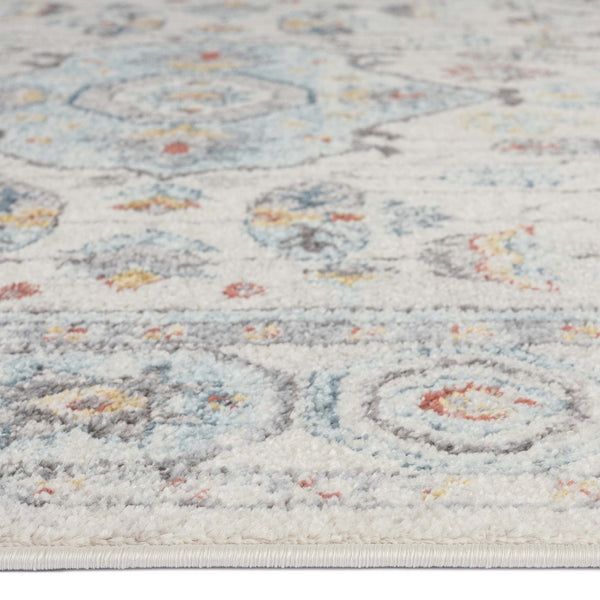 Close-up of a blue multi-coloured geometric patterned runner rug with soft texture and intricate detailing.