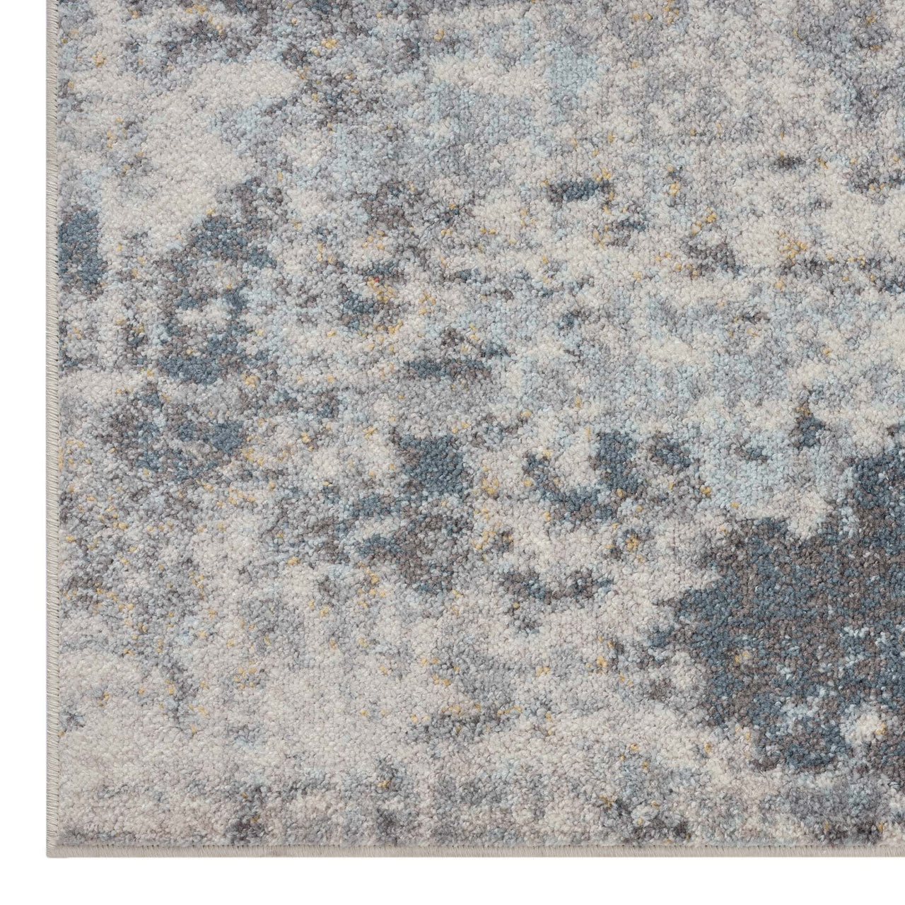 Grey multi-coloured abstract patterned rug with textured, modern design.