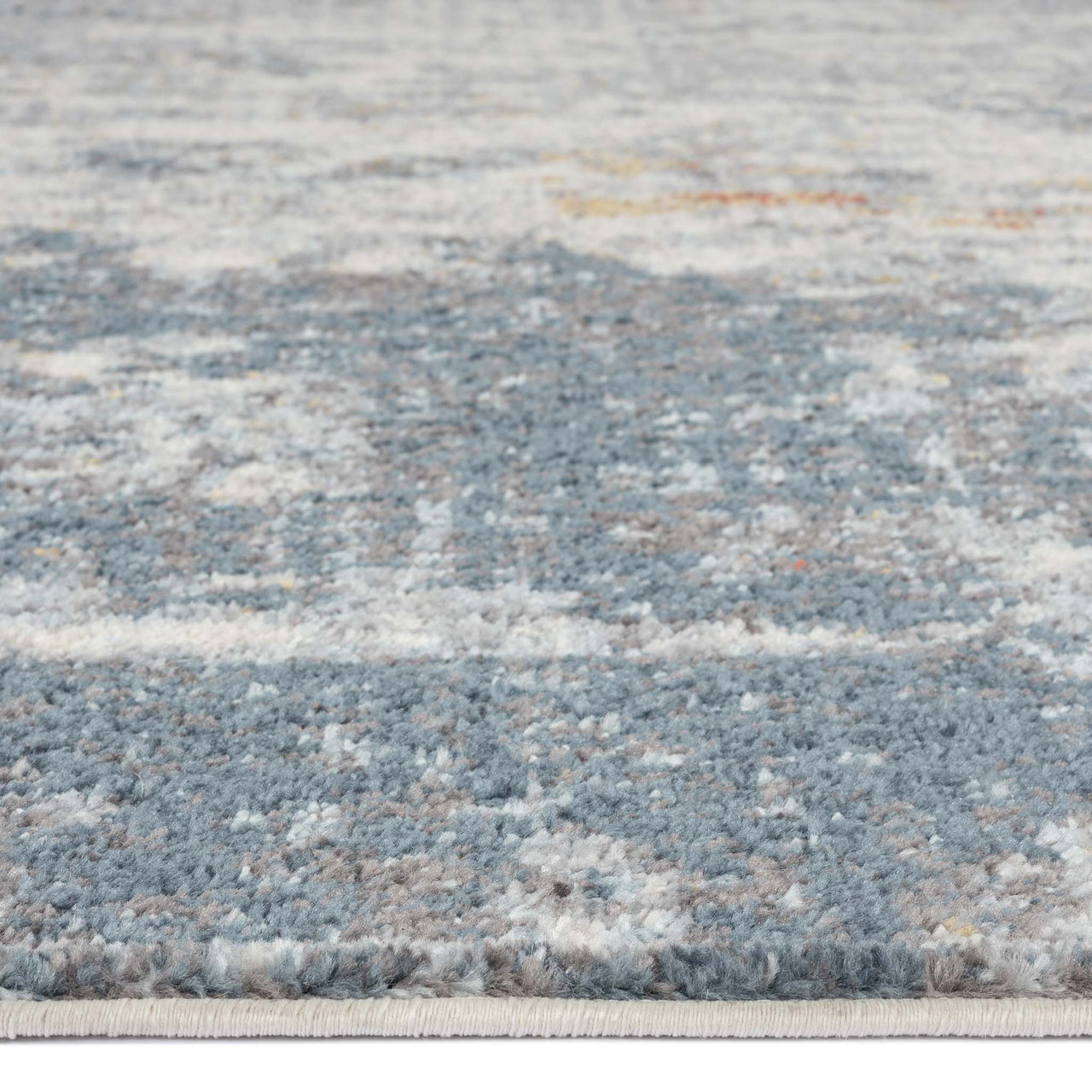 Grey multi-colored abstract patterned rug with textured, soft polypropylene fibers.