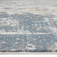 Grey multi-colored abstract patterned rug with textured, soft polypropylene fibers.