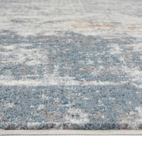 Grey and blue abstract patterned runner rug with hints of beige and rust tones.