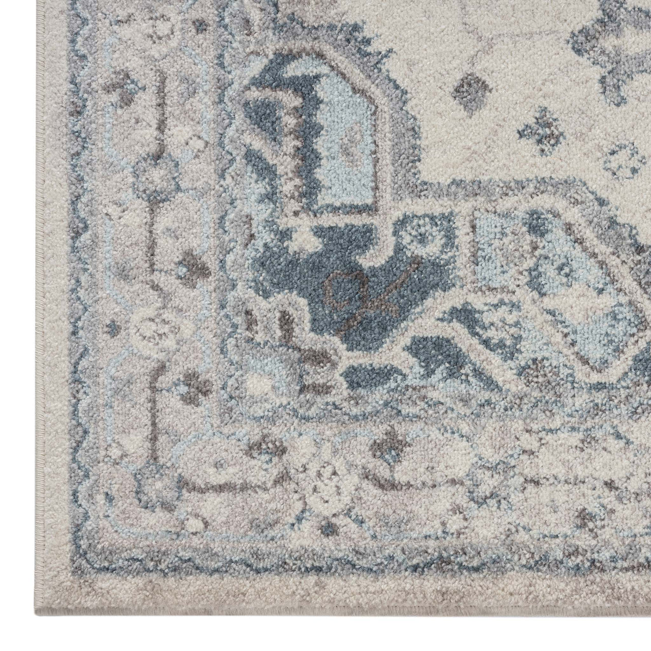 Blue and beige multi-colored transitional patterned rug corner with intricate geometric details and subtle texture.