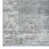 Grey rug with white and blue abstract pattern and subtle textured design.