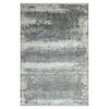 Grey white and blue abstract patterned modern rug with soft textured surface.