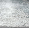Grey and white abstract patterned modern rug with subtle blue accents and soft texture.