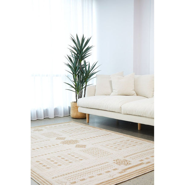 Natural cream flatweave rug with subtle geometric patterns in a modern indoor living space.