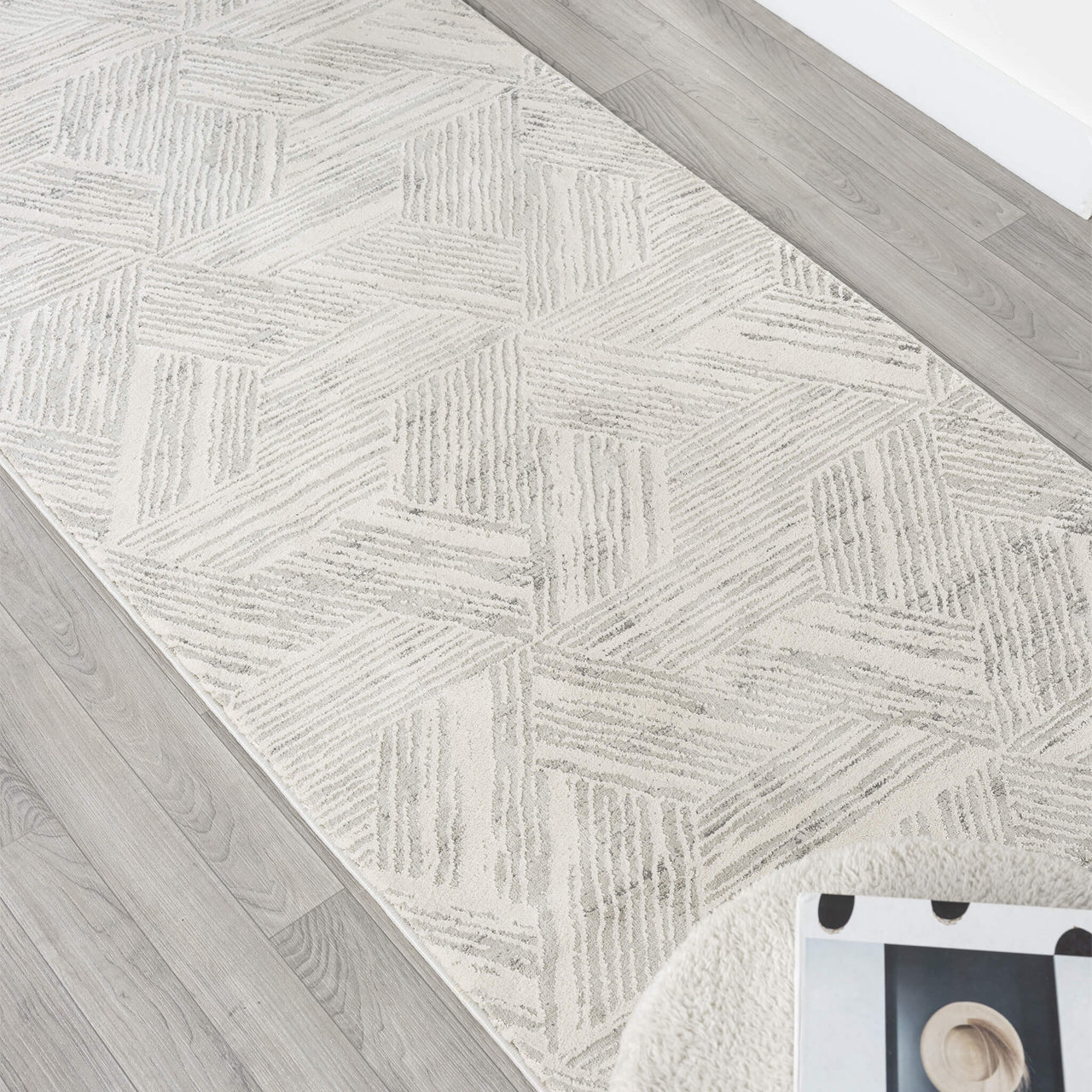 Light grey geometric textured runner rug with modern linear pattern on hardwood floor.
