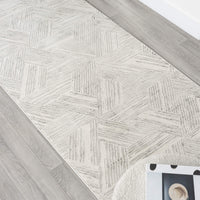 Light grey geometric textured runner rug with modern linear pattern on hardwood floor.