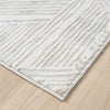 Light grey runner rug with geometric textured pattern and subtle raised lines on wood floor.