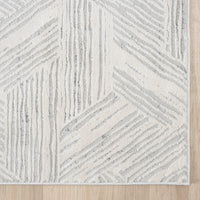 Light grey runner rug with textured geometric lines and soft neutral tones.