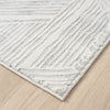 Light grey modern rug with geometric textured pattern and soft pile on wooden floor.