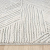 Light grey modern rug with geometric textured patterns and raised pile on neutral background.