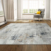 Grey multi-colored abstract modern rug with textured pile on wooden floor.