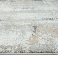 Grey multi-colored abstract rug with textured pile and soft neutral tones.