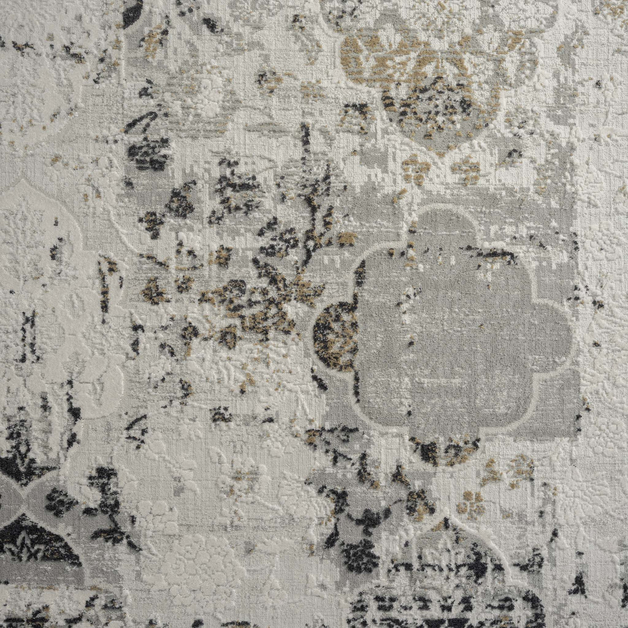 Grey multi-color textured rug with abstract floral and geometric patterns in neutral tones.