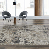 Grey multi-color abstract textured rug with neutral tones and modern pattern on wood floor.