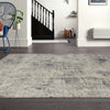 Grey multi-color textured modern rug with subtle abstract pattern on dark hardwood floor.