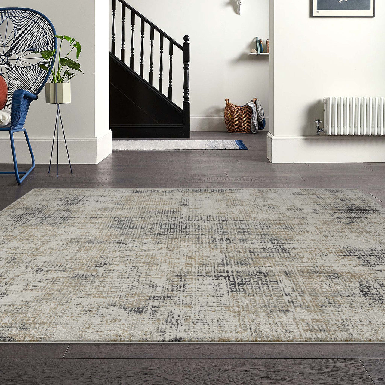 Grey multi-color textured modern rug with subtle abstract pattern on dark hardwood floor.