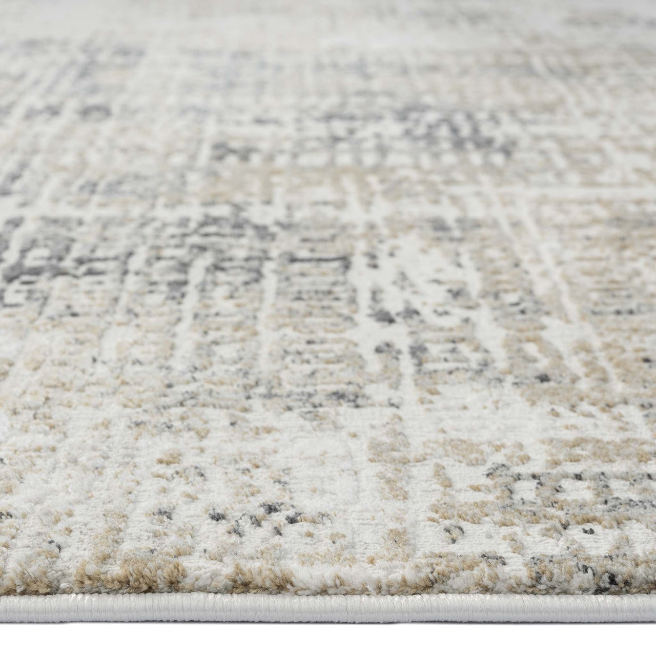Grey multi-colored modern rug with textured, abstract patterned pile and neutral tones.