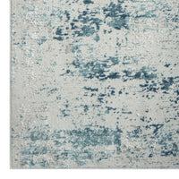 Blue and beige textured modern rug with abstract distressed pattern and soft, multi-tonal pile.