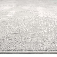 Light grey modern rug with subtle textured pattern and soft, neutral tones.