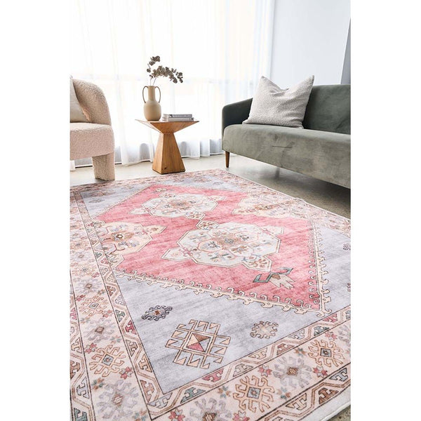 Transitional pink and beige patterned machine-washable rug with geometric and floral motifs.