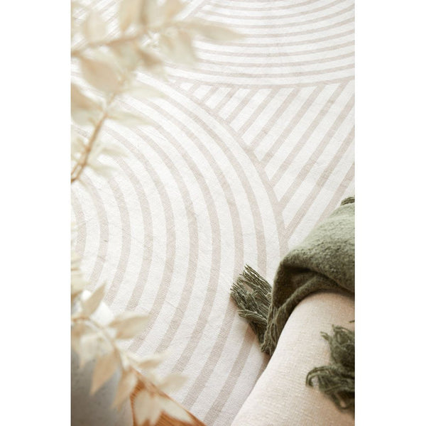 Natural beige rug with subtle geometric arches pattern in soft white tones.