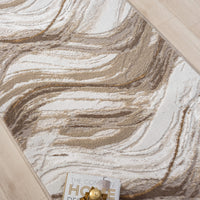 Beige and brown modern runner rug with abstract wavy pattern on light wood floor.