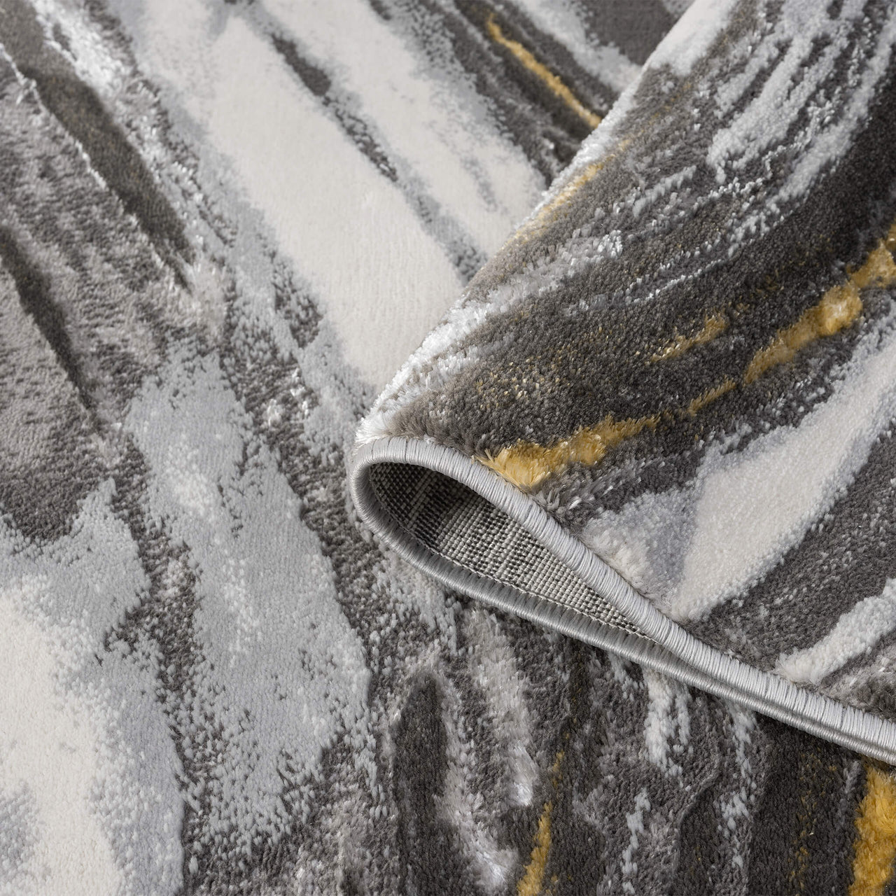 Grey runner rug with abstract wavy patterns in white, charcoal, and mustard yellow tones.