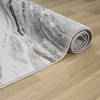 Grey runner rug with abstract wavy pattern in shades of grey, white, and beige on wooden floor.