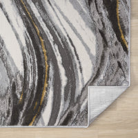 Modern grey rug with abstract wavy pattern and subtle mustard accents, folded corner reveals backing.