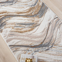 Beige runner rug with abstract wavy patterns in gray, brown, and cream tones on light hardwood floor.