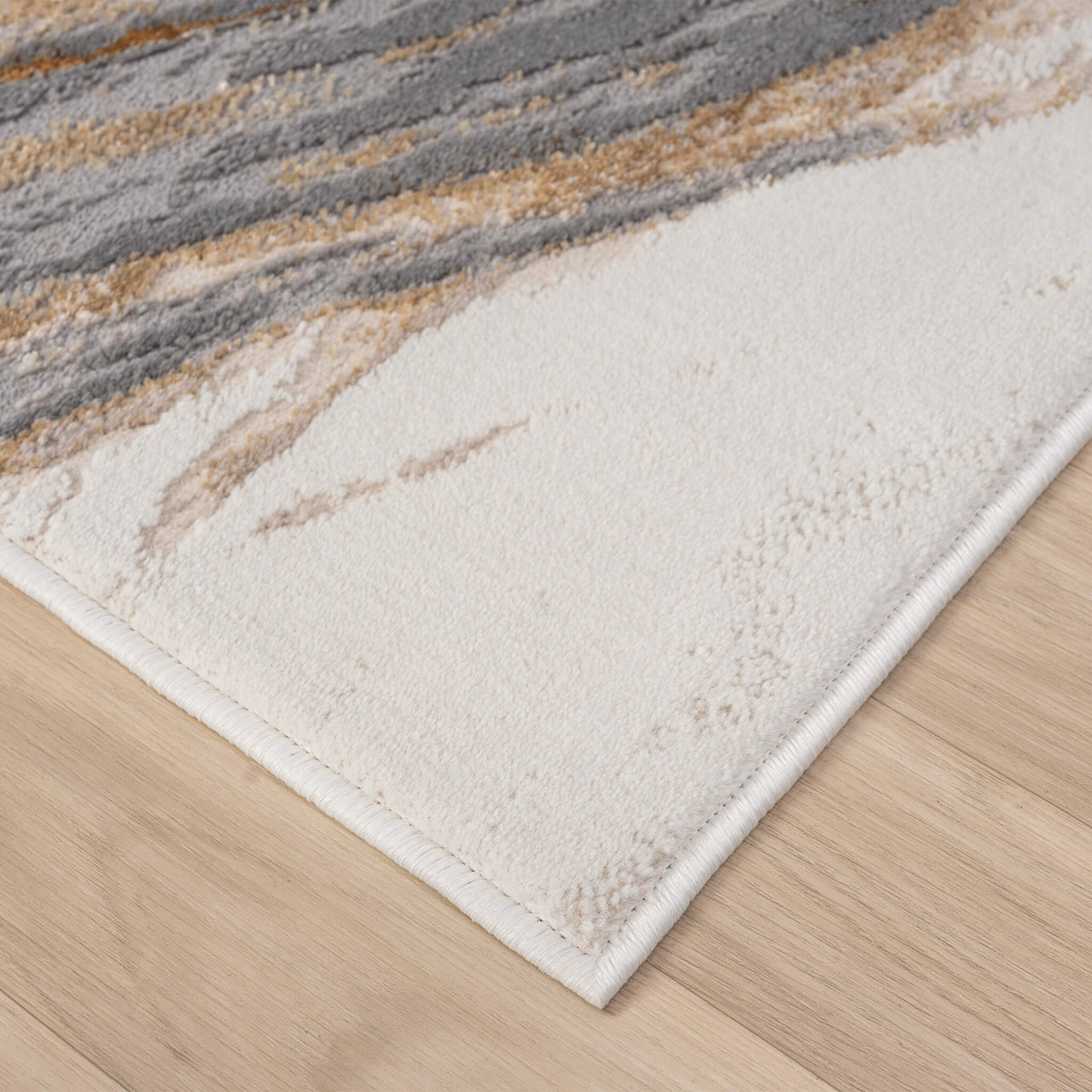 Beige modern rug corner with multi-color wavy abstract pattern and clean edges on wooden floor.