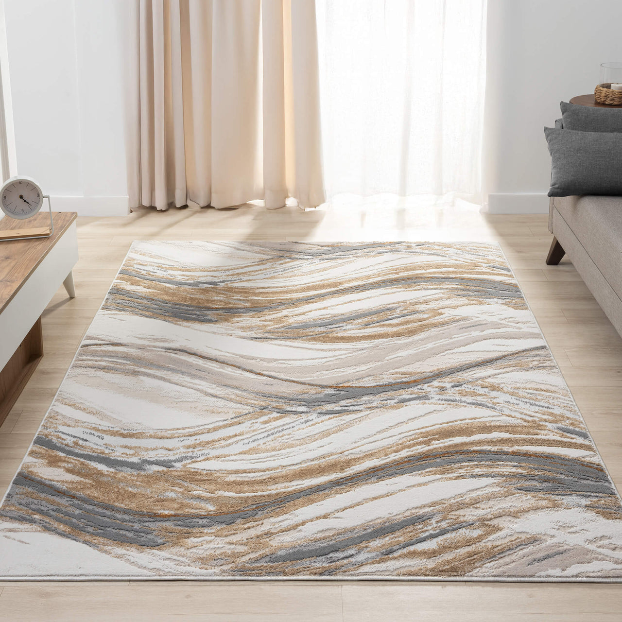 Beige modern rug with abstract wavy pattern in blue, gray, and gold tones on a light background.