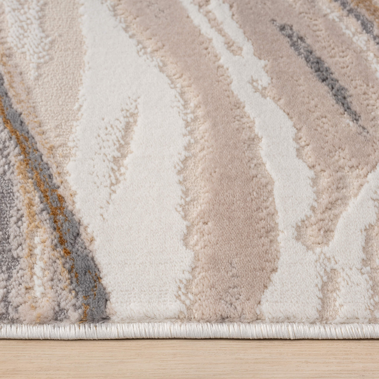 Beige modern rug with wavy abstract pattern in cream, taupe, gray, and mustard tones.