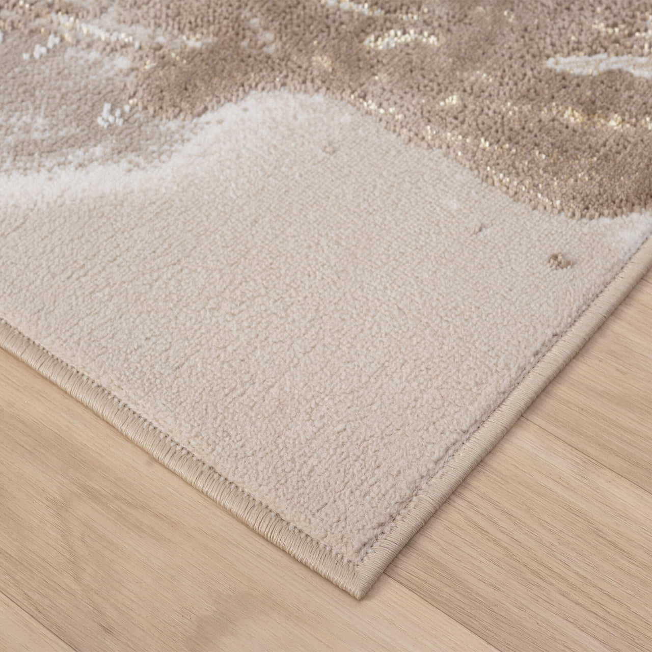 Beige runner rug corner with abstract gold and multi-color pattern, soft polyester texture.