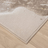 Beige runner rug corner with abstract gold and multi-color pattern, soft polyester texture.