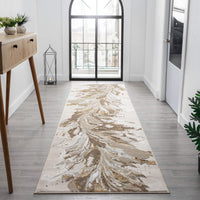 Beige and gold abstract patterned modern runner rug in bright hallway with wood floor.