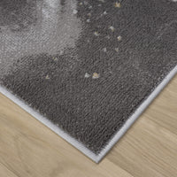 Close-up of grey runner rug corner with subtle multi-color abstract pattern and white stitched border on wood floor.