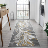 Grey runner rug with abstract swirling white and gold patterns on a modern hallway floor.