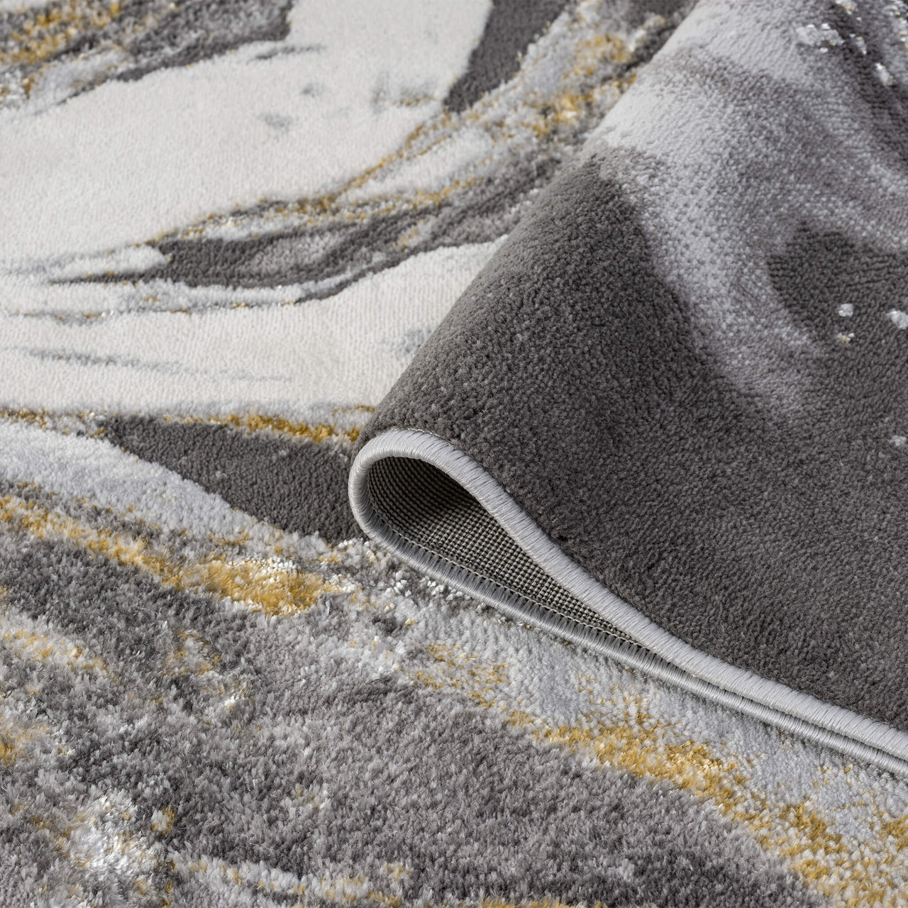 Grey runner rug with abstract multi-color pattern in shades of white, yellow, and muted gold, soft polyester texture,.