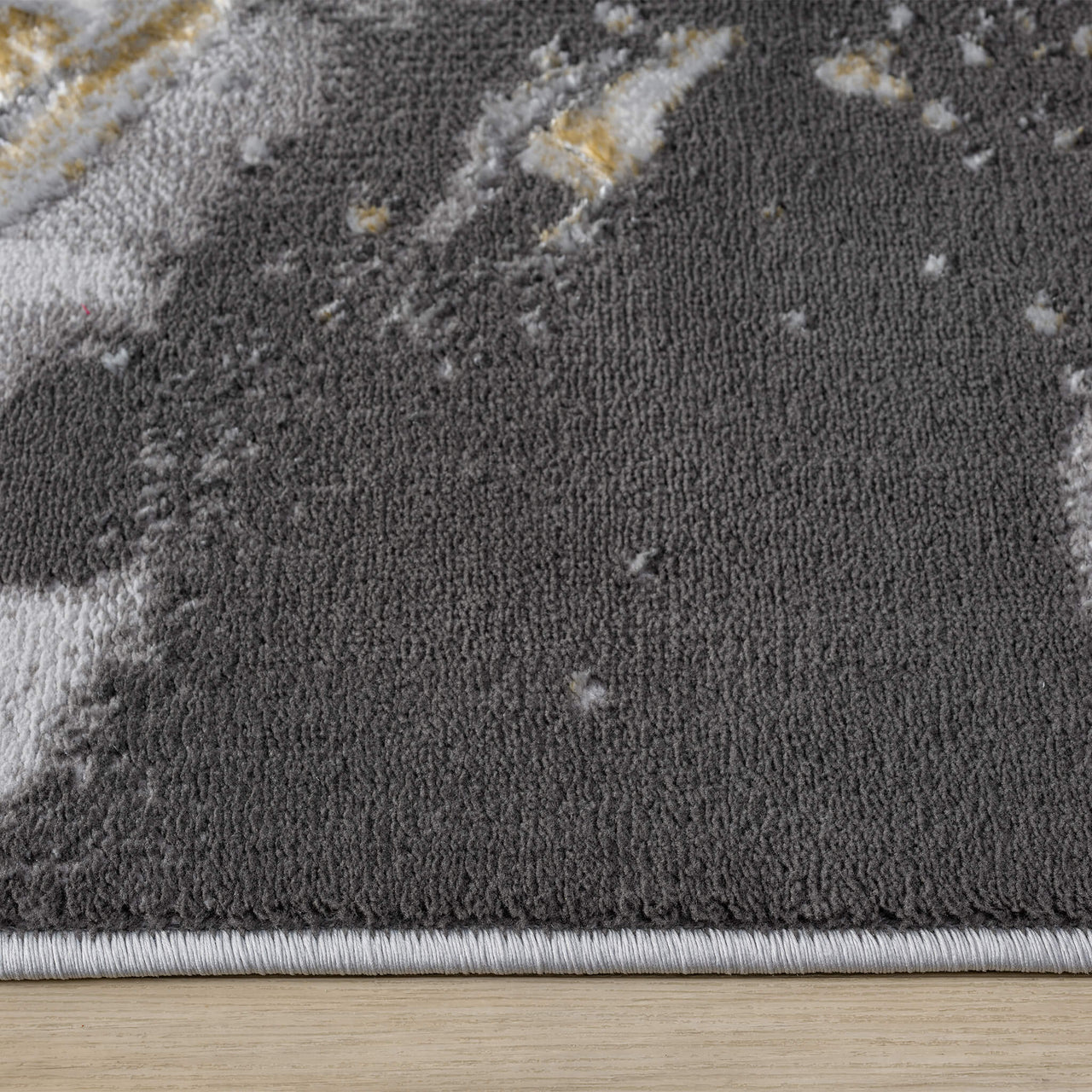Grey runner rug with abstract multi-colour pattern in white and yellow tones, soft textured polyester surface.