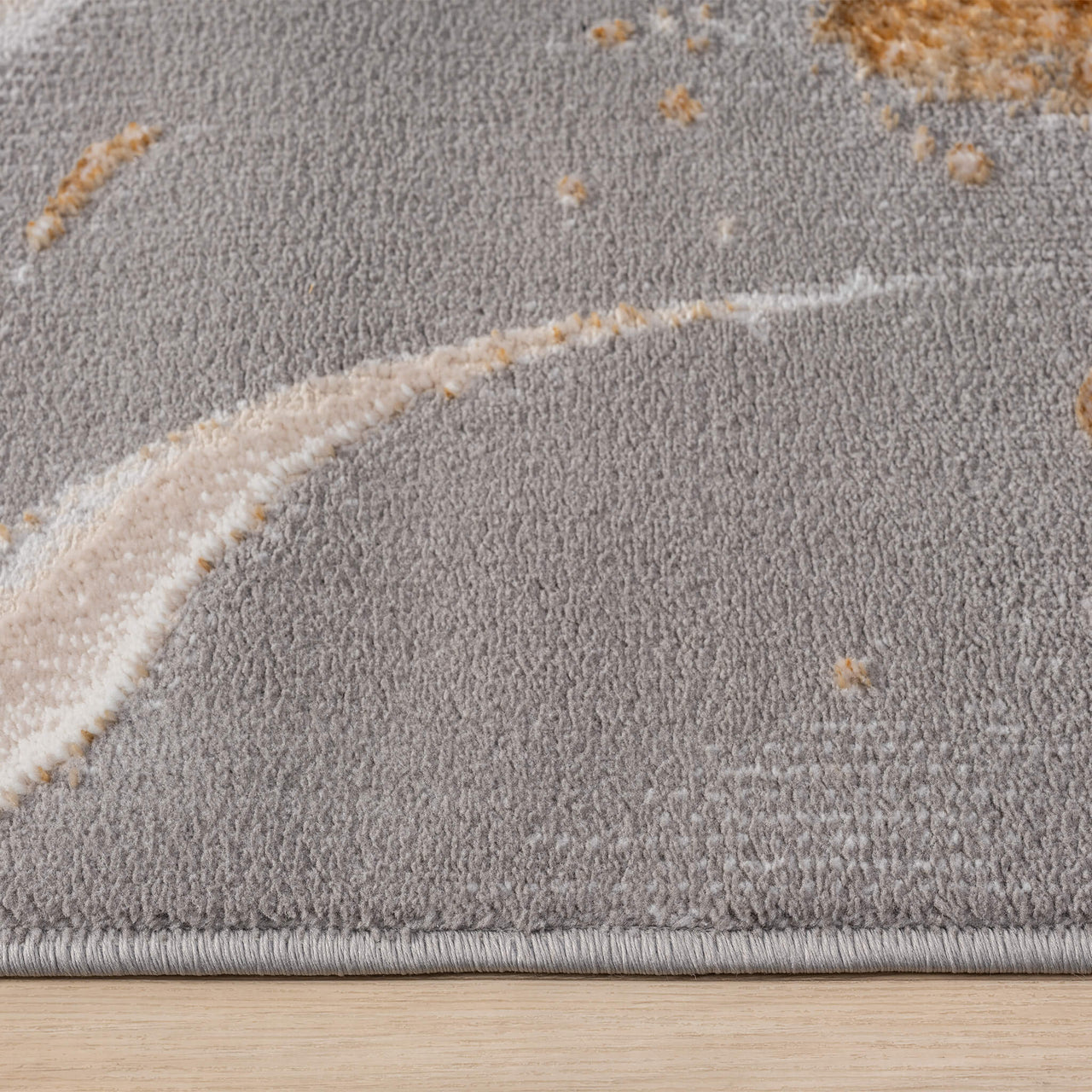 Close-up of beige modern runner rug with abstract multi-color pattern and soft texture.