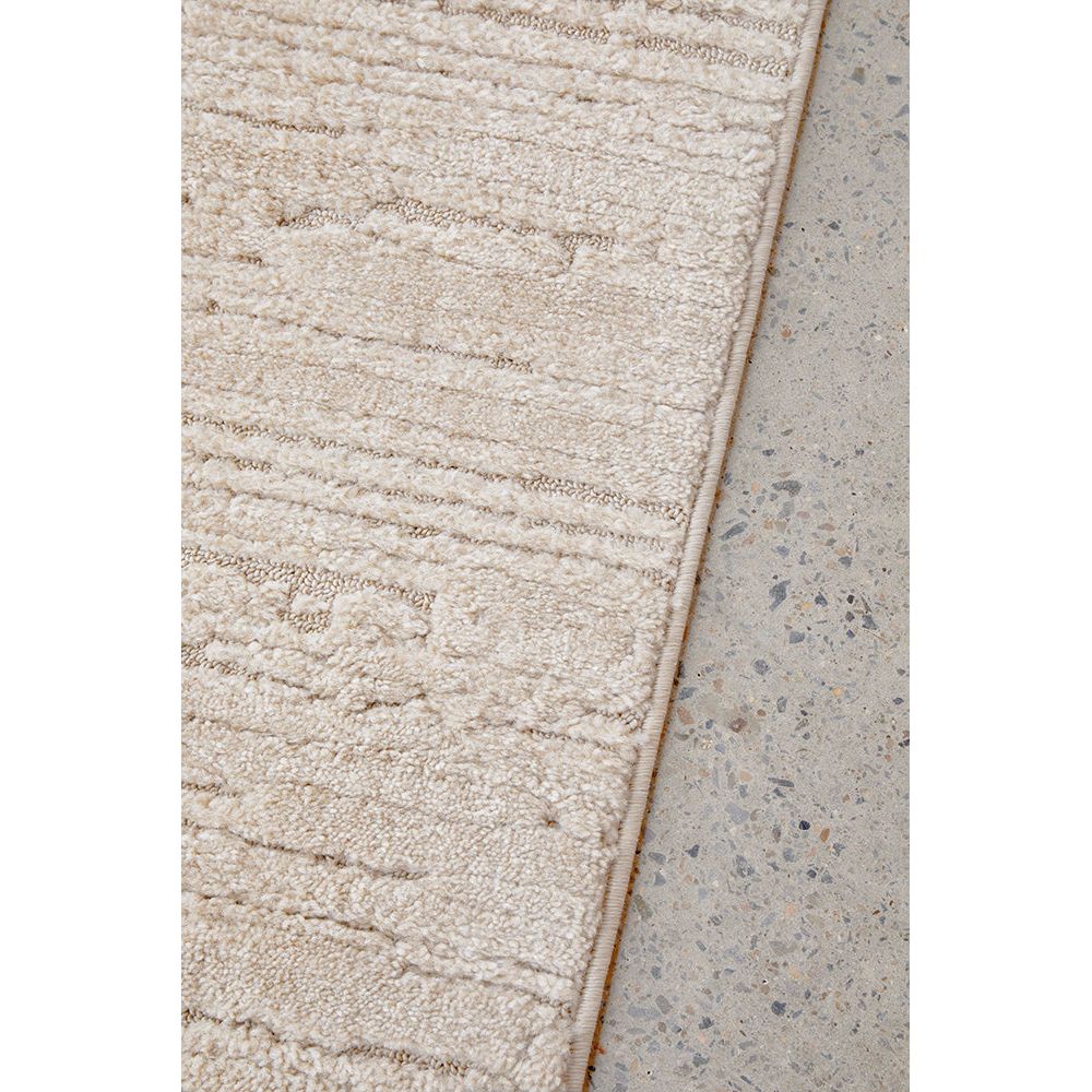 Beige textured rug on a concrete floor
