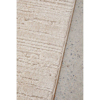 Beige textured rug on a concrete floor