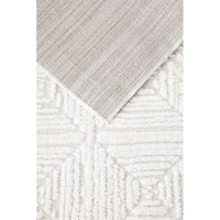 Close-up of textured beige and white rug with geometric pattern