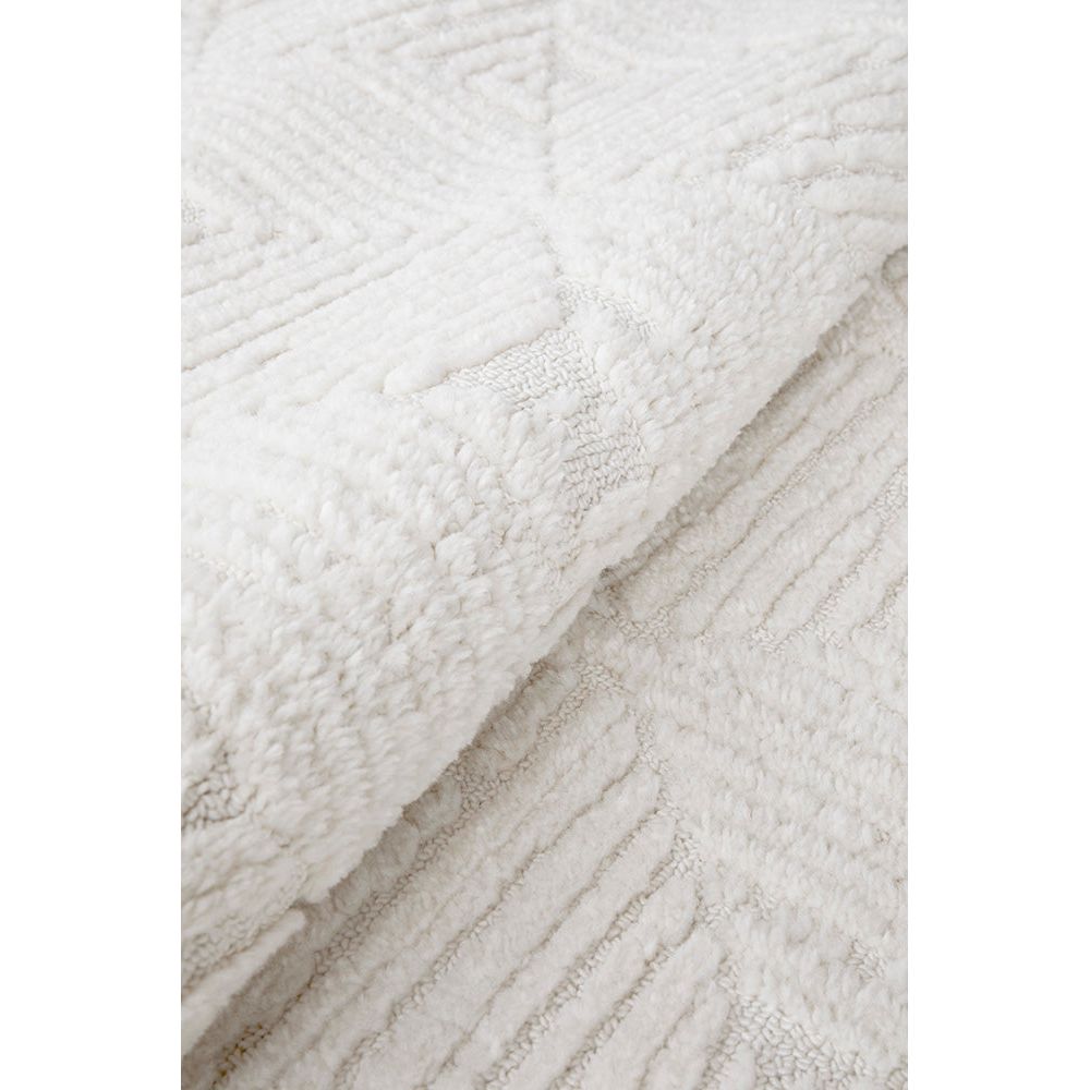Close-up of textured white fabric with a subtle pattern