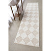Patterned rug on a concrete floor with a wooden side table.